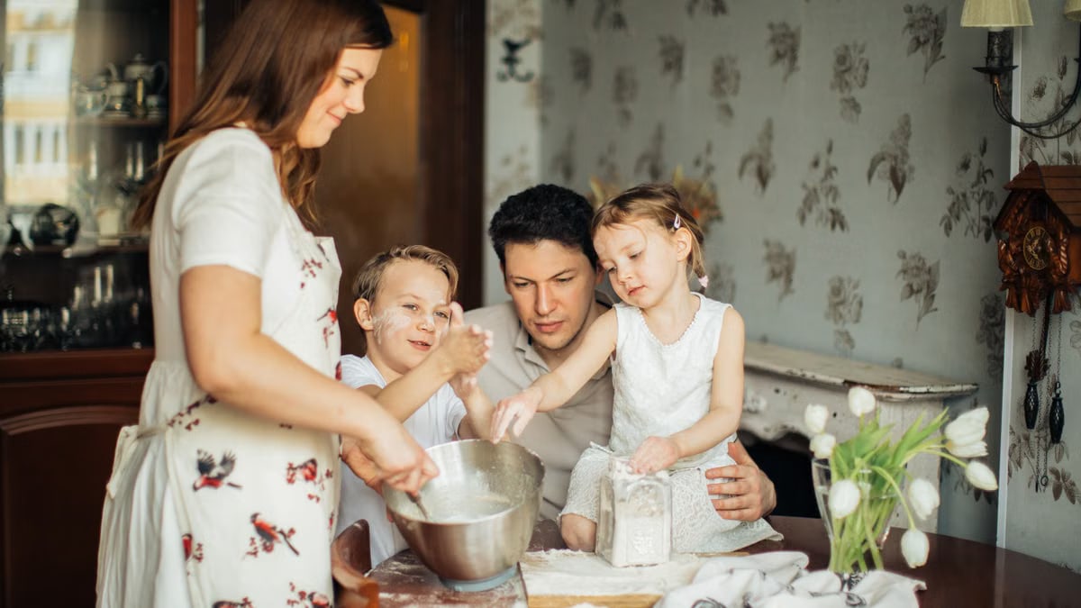 A joyful family bakes together in a cozy kitchen setting, creating lasting memories.